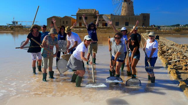 Fun beyond compare while we harvest salt at the saline in Trapani, Sicily - Truly a unique experience! 